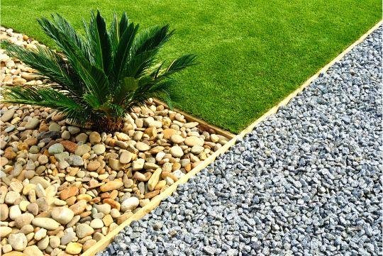 landscape with small stones, sand and green lawn